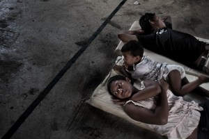 Coatzacoalcos, Veracruz, Mexico, 2011 A family from Honduras rest in a church in the outskirts of the city of Coatzacoalcos as they wait for the next train to pass by. Source: The Borderland Chronicles