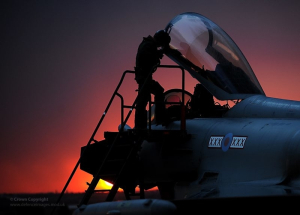 A Royal Air Force Typhoon pilot enters the cockpit as the sun sets over Gioia del Colle, southern Italy. As RAF Typhoon aircraft play a greater part in deliberate targeting operations, where targets are pre-planned, more are carrying four of the 1000lb Enhanced Paveway II bombs. The aircraft's ability to use its Litening III targeting pod to direct the highly accurate bombs means that a single Typhoon can have a devastating effect on Qadhafi regime targets. This image is available for non-commercial, high resolution download at www.defenceimages.mod.uk subject to terms and conditions. Search for image number 45152844.jpg ---------------------------------------------------------------------------- Photographer: Sgt Pete Mobbs Image 45152844.jpg from www.defenceimages.mod.uk