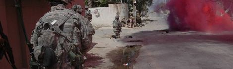 Iraqi troops run through a smoke screen in Baqubah, Iraq, 22 June 2007, followed by US troops from the 3rd Stryker Brigade Combat Team. The action was part of Operation Arrowhead Ripper to defeat al-Qaida in Iraq as part of the Diyala campaign.