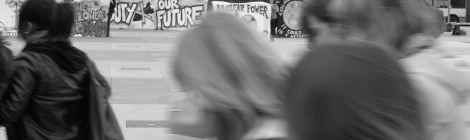 Young people walk past an anti-nuclear weapons protest outside the NPT Review Conference, Geneva, 2008 Source: BANG (Flickr)